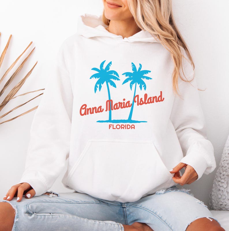May include: White hoodie with a blue and red graphic of two palm trees and the text "Anna Maria Island, Florida".