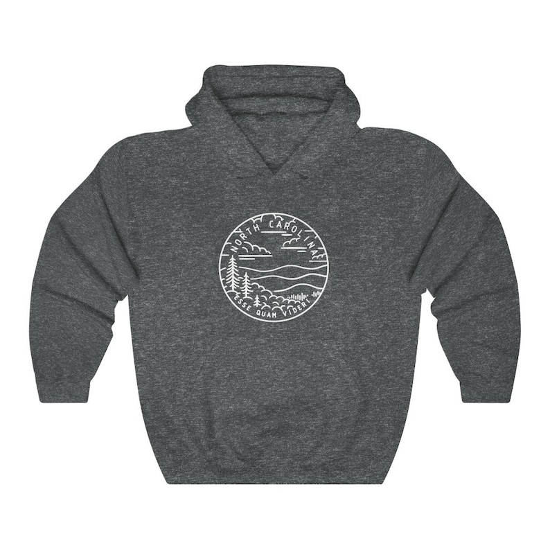 May include: A dark grey hooded sweatshirt with a white outline of a circle containing the words "North Carolina" and a landscape scene with trees, mountains, and clouds. The text "Esse Quam Videri" is written below the landscape.