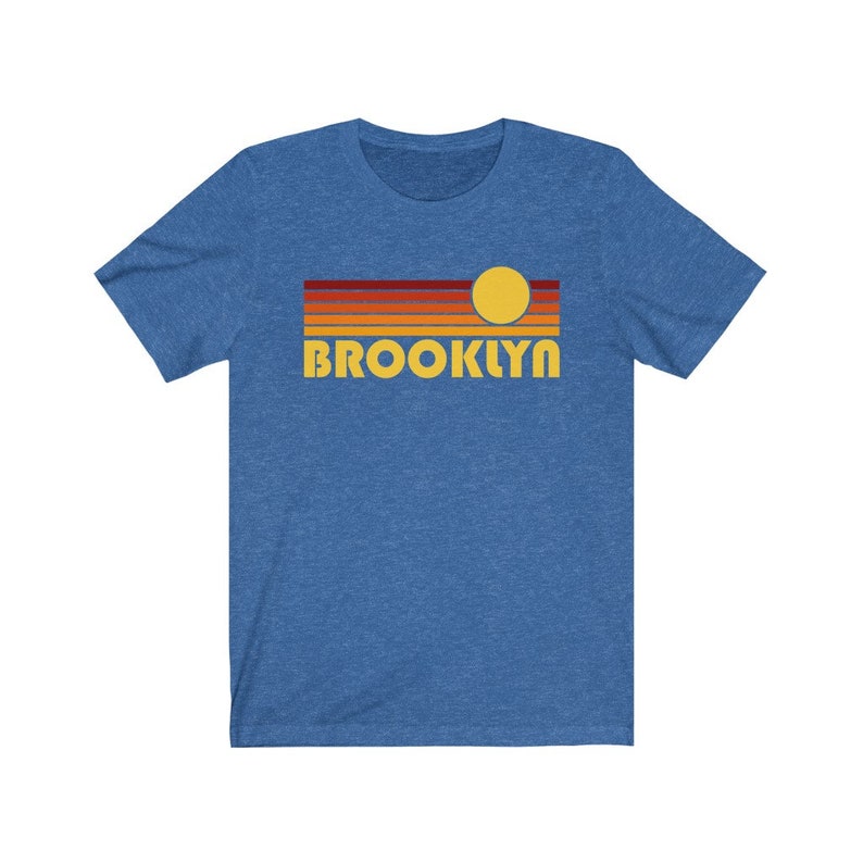 May include: A blue t-shirt with a retro sunset graphic and the word "BROOKLYN" in yellow letters.