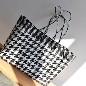 May include: A white ceramic mug with a colorful floral design. The mug features a handle and a wide rim. The floral pattern includes pink, yellow, and blue flowers with green leaves. The mug is likely for beverages.