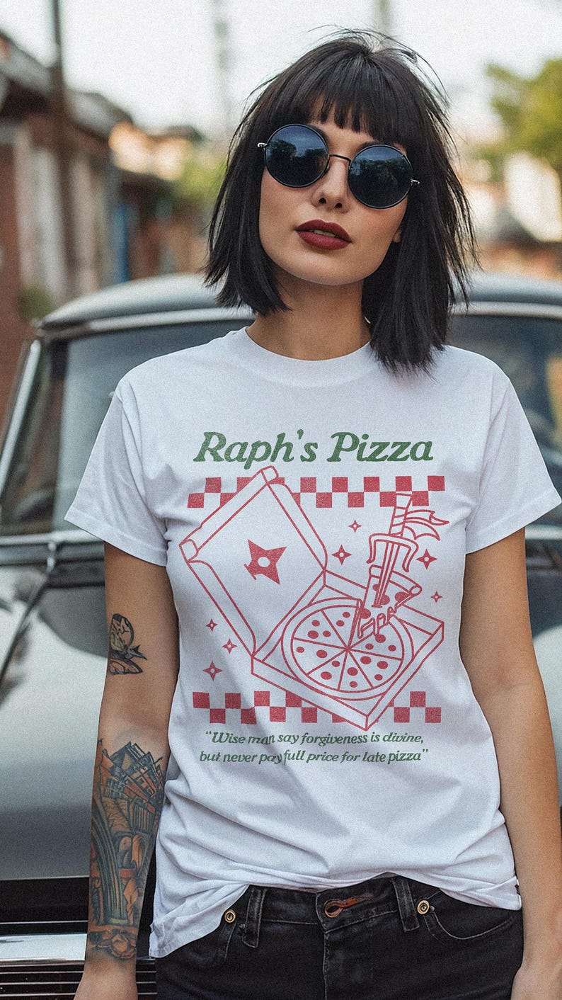 May include: White t-shirt with a red and white pizza box graphic and the text "Raph's Pizza". The pizza box is open and a pizza slice is being pulled out with a sword. The text below the graphic says "Wise man say forgiveness is divine, but never pay full price for late pizza."