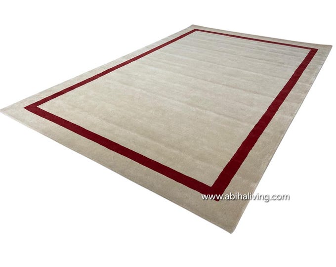 Hand Tufted Wool Rug with viscose border design.