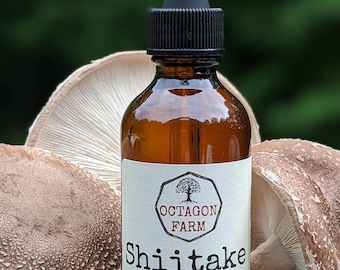 May include: A brown glass bottle with a black dropper lid and a white label. The label says "Octagon Farm" and "Shiitake double extraction tincture 2 fl oz crafted in Fletcher, VT". The bottle is sitting on a wooden surface with two shiitake mushrooms.