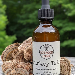 May include: A brown glass bottle with a black dropper top, labeled "OCTAGON FARM Turkey Tail double extraction tincture 2 fl oz crafted in Fletcher, VT".