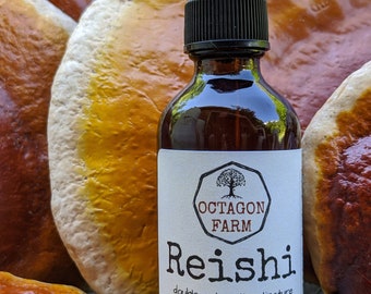 May include: A 2 fl oz bottle of Reishi double extraction tincture from Octagon Farm, crafted in Fletcher, VT. The bottle is brown glass with a black dropper lid and a white label with black text. The bottle is surrounded by several large, brown and orange mushrooms.