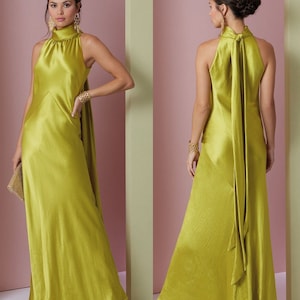May include: A long, green satin dress with a high neck and a bow tie at the back.