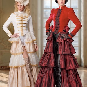 May include: Two women in elaborate steampunk-inspired costumes. One wears a white jacket with gold trim and a tiered skirt. The other dons a red velvet jacket, black pants, and a tiered skirt. Both outfits feature hats and boots, showcasing a Victorian aesthetic.