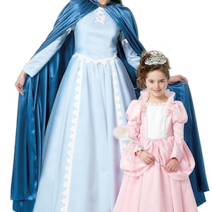 May include: Two women in princess costumes. One wears a light blue gown and cape, the other a pink dress, tiara and wand. The dresses have white lace trim. The cape is a deep blue colour.