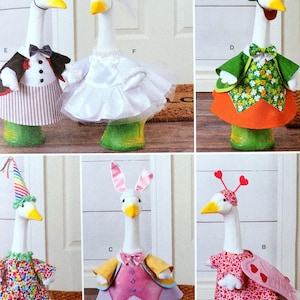 May include: A collection of decorative goose figurines dressed in various outfits. One goose wears a tuxedo and top hat, another a wedding dress, and others are in whimsical costumes, including a bunny and a jester.