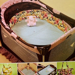 May include: A pink and brown portable crib with a floral patterned bumper pad and a blue mesh mattress. The crib is set up and includes a stuffed animal toy. The image also shows close-ups of a diaper bag, a changing pad, and a crib sheet.