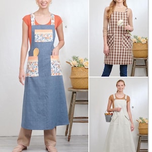 Pode incluir: Três estilos diferentes de aventais compridos. O primeiro avental é xadrez marrom e branco com dois bolsos. O segundo avental é azul com estampa floral e dois bolsos. O terceiro avental é branco com listras verticais finas e dois bolsos. Todos os aventais têm alças ajustáveis.