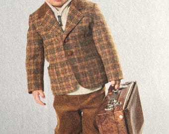 May include: A young person in a brown plaid blazer, corduroy pants, and boots, holding a brown suitcase. The blazer has a two-button closure and is worn over a cream-colored sweater. The outfit is a vintage style.