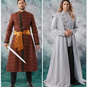 May include: Two fantasy costumes are displayed. One is a long, reddish-brown coat with gold detailing, a gold sash, and a sword. The other is a long, grey coat with a high collar and button details.