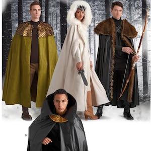 May include: A selection of fantasy-themed capes and cloaks in various colours. The capes include olive green, black, and white. Some have fur trim, hoods, and decorative details. One model holds a bow and arrow, another a sword.