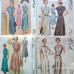 May include: Four vintage McCall's printed sewing pattern envelopes featuring illustrations of various dress styles. The patterns include designs with stripes, solid colors, and floral prints, showcasing different necklines, waist belts, and skirt silhouettes.