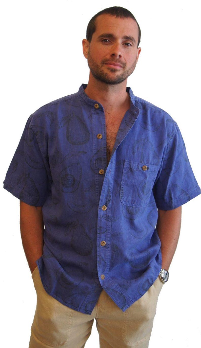 May include: A blue short-sleeved button-down shirt with a black avocado print. The shirt has a mandarin collar and a chest pocket.