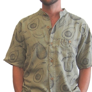 May include: A man wearing a green short-sleeved shirt with a black and white avocado print. The shirt has a mandarin collar and a button-up front.