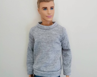 May include: A gray long-sleeved sweater with a mock neck.