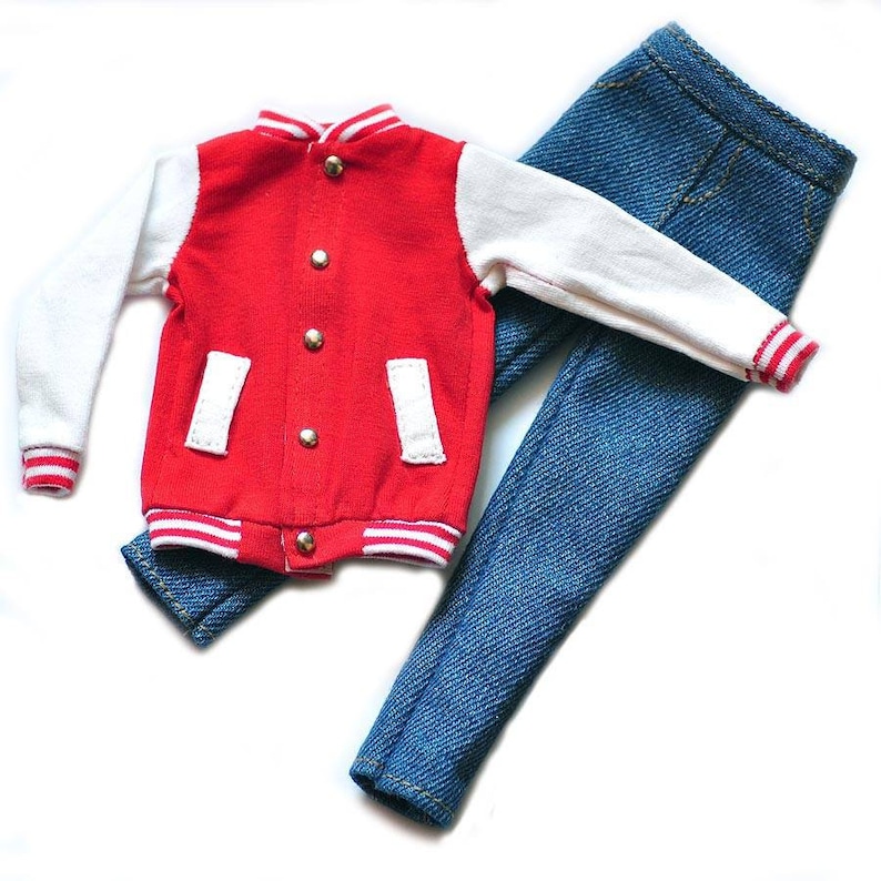 May include: A red and white varsity jacket with a zipper closure and snap buttons. The jacket has white sleeves and red stripes on the cuffs and hem. The jacket is paired with blue denim jeans.