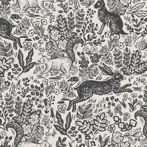 May include: A black and white repeating pattern featuring stylized illustrations of rabbits, squirrels, and flowers. The background is a light cream color.