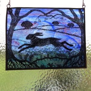 Racing Hare in Evening light, hand painted and etched stained glass window panel