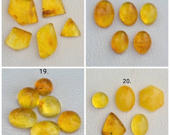 May include: Assortment of amber gemstones in various shapes and sizes, including oval, round, and triangular. The gemstones are a light yellow color and have a translucent appearance. The image is labeled with numbers 17, 18, 19, and 20.