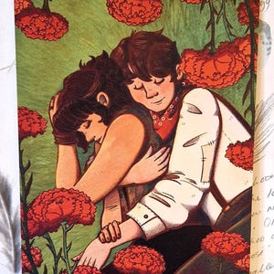 May include: Illustration of two figures embracing amidst red flowers and green foliage. One figure wears a white jacket and red scarf, while the other is in a dark top. The artwork has a warm, inviting color palette.