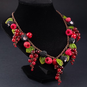 May include: A handmade necklace with a bronze chain, decorated with polymer clay berries. The necklace features red raspberries, black blackberries, redcurrants, and green leaves, creating a vibrant, nature-inspired design.