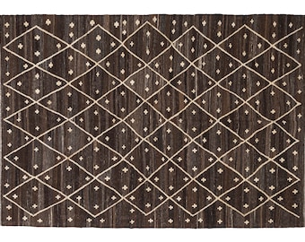 May include: A brown and white geometric patterned rug with a diamond and cross design.