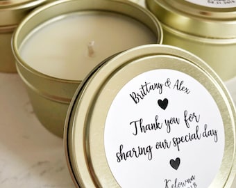 May include: Gold metal candle tins with white labels. The labels have black text that reads "Brittany & Alex Thank you for sharing our special day Kelowna 08.31.2018".