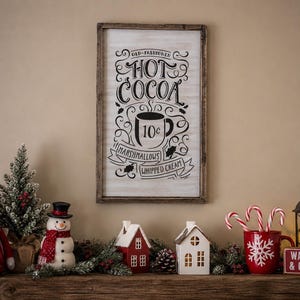 May include: A rectangular wooden sign with a white background and black text that reads Old-Fashioned Hot Cocoa, featuring a mug graphic labelled 10c, with banners for Marshmallows and Whipped Cream, framed in dark brown wood.