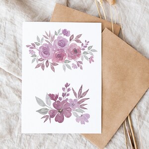 May include: Two watercolor floral illustrations on a white card. The top illustration features a bouquet of purple and gray roses with green leaves. The bottom illustration features a cluster of purple flowers with green leaves.