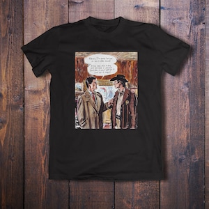 May include: A black t-shirt with a comic book style illustration of two men talking. The text in the speech bubble says "Harry, I'm gonna let you in on a little secret. Every day, once a day, give yourself a present. Don't plan it, just wait for it. Just let it happen."