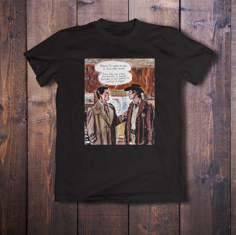 May include: A black t-shirt with a comic book style illustration of two men talking. The text in the speech bubble says "Harry, I'm gonna let you in on a little secret. Every day, once a day, give yourself a present. Don't plan it, just wait for it. Just let it happen."