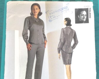 May include: A Vogue Attitudes sewing pattern, featuring a woman in a gray suit with pants and a matching jacket. The pattern includes a sketch of a skirt suit. The pattern number is 2043, with sizes 8-10-12. The Fabricland stamp is visible.