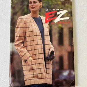 May include: Vintage Vogue Ultra EZ pattern 8466. The pattern cover features a woman wearing a tan and black plaid coat. The coat has large pockets and a classic design. The pattern is for sizes 8-10-12.