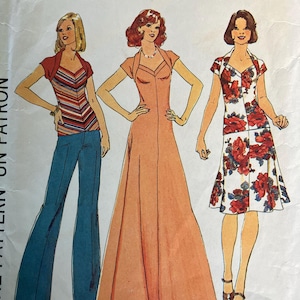 May include: Vintage sewing pattern featuring three women's fashion designs. The pattern includes a striped top with flared jeans, a long peach dress, and a floral print dress. The pattern is size 10 with a 32 1/2 inch bust.