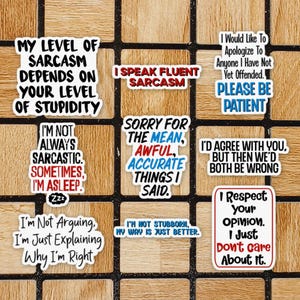 May include: Nine white stickers with black text and blue and red accents. The stickers feature humorous sayings about sarcasm, being sarcastic, and being right. The stickers are arranged in a grid on a wooden surface.