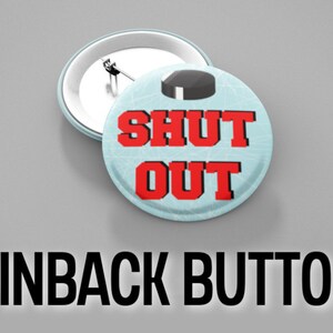 May include: A blue and white pinback button with a hockey puck on top and the text "SHUT OUT" in red.