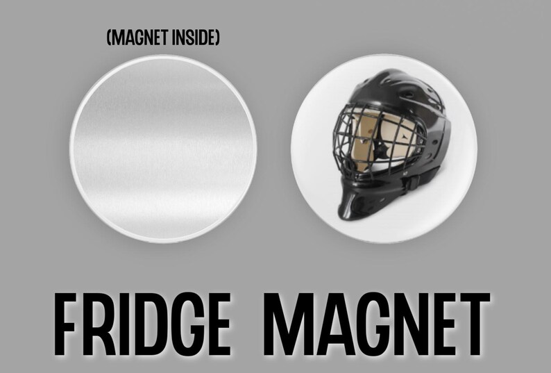 May include: A black and white image of a hockey goalie mask fridge magnet. The magnet is round and has a white background. The text (MAGNET INSIDE) is printed on the top of the magnet. The text FRIDGE MAGNET is printed below the magnet.
