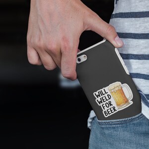 May include: A black phone case with a white sticker that says "Will Weld For Beer" and a cartoon image of a beer mug.