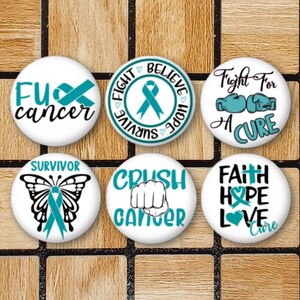 May include: Set of six round white buttons with teal blue ribbon and text designs. The buttons feature phrases like "Fight Survive Believe Hope", "Crush Cancer", "Faith Hope Love Cure", "Fight For A Cure", "Survivor", and "F**k Cancer".