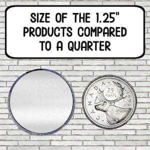 May include: A 1.25 inch round button or pin compared to a Canadian quarter coin. The button is silver and the coin is silver with a caribou design.