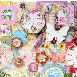 May include: A collage of paper crafts with a floral theme. The collage includes butterflies, flowers, hearts, and other decorative elements. The words "Love You" are featured in a circle with a floral design.