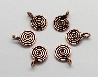 May include: Six copper-colored metal charms with a spiral design. Each charm has a small loop at the top for attaching to jewelry or other crafts.