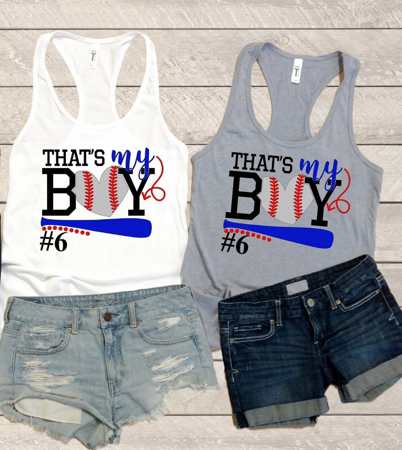 May include: Two white tank tops with a baseball graphic and the text "That's my boy #6". One tank top is white and the other is grey.