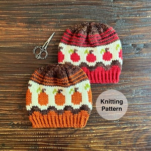 May include: Two knitted hats with a pumpkin pattern. The hat on the left has a brown, orange, and white pattern. The hat on the right has a red, white, and brown pattern. The text "Knitting Pattern" is visible in the image.