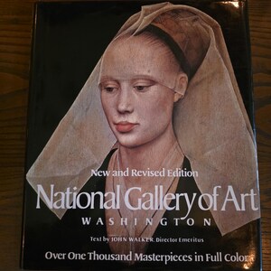 Puede incluir: Un libro de tapa dura titulado National Gallery of Art Washington, New and Revised Edition, con texto de John Walker, director emérito. La portada presenta el retrato de una persona con un tocado, con el subtítulo Over One Thousand Masterpieces in Full Color impreso en texto blanco sobre un fondo negro.