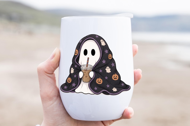 Digital PNG design showing a sweet ghost tucked under a black blanket with purple edging, pumpkin faces, tiny ghosts, and stars.