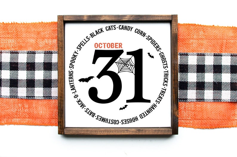 May include: A wooden framed Halloween sign with the number 31 in black, the word "October" in orange, and a spider web graphic. The sign is surrounded by Halloween-themed words and bat silhouettes. An orange burlap and black and white checkered ribbon are in the background.
